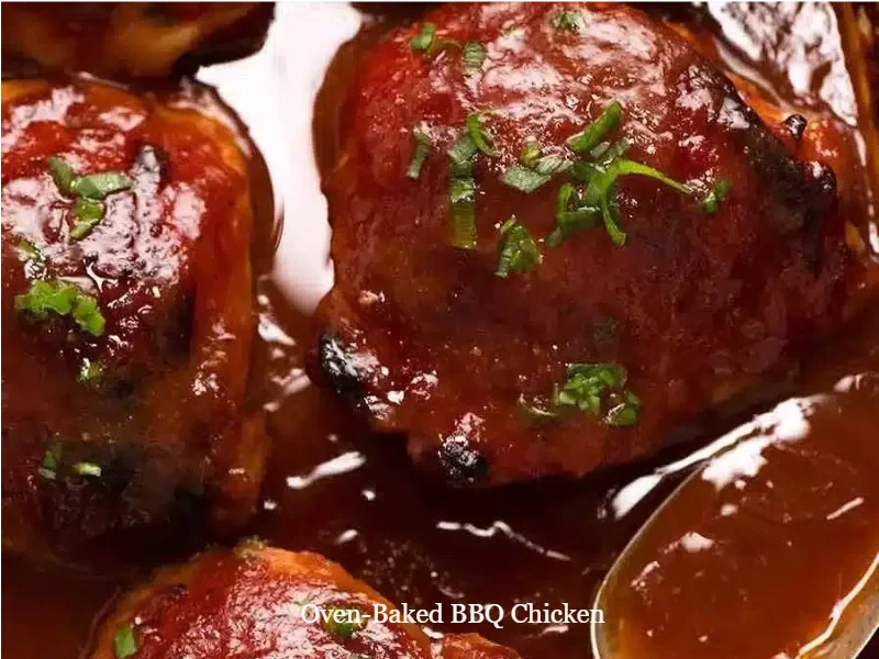 Oven-Baked BBQ Chicken 1 Oven-baked BBQ chicken ready to serve on a plate with fresh herbs.
