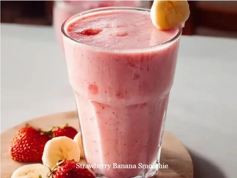 Strawberry Banana Smoothie 1 Strawberry banana smoothie in a glass with fresh fruit